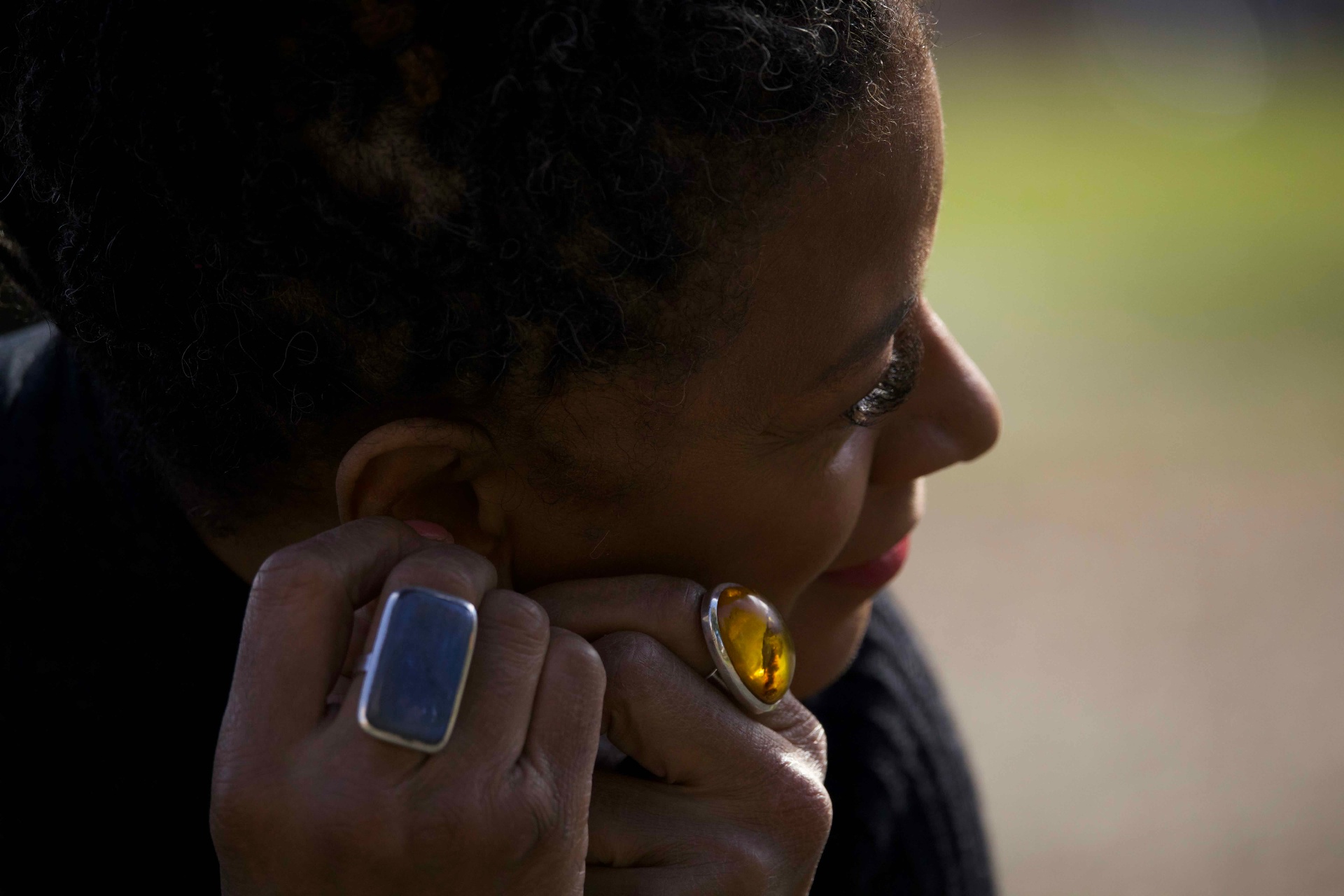 Close portrait of Traciana wearing an amber ring